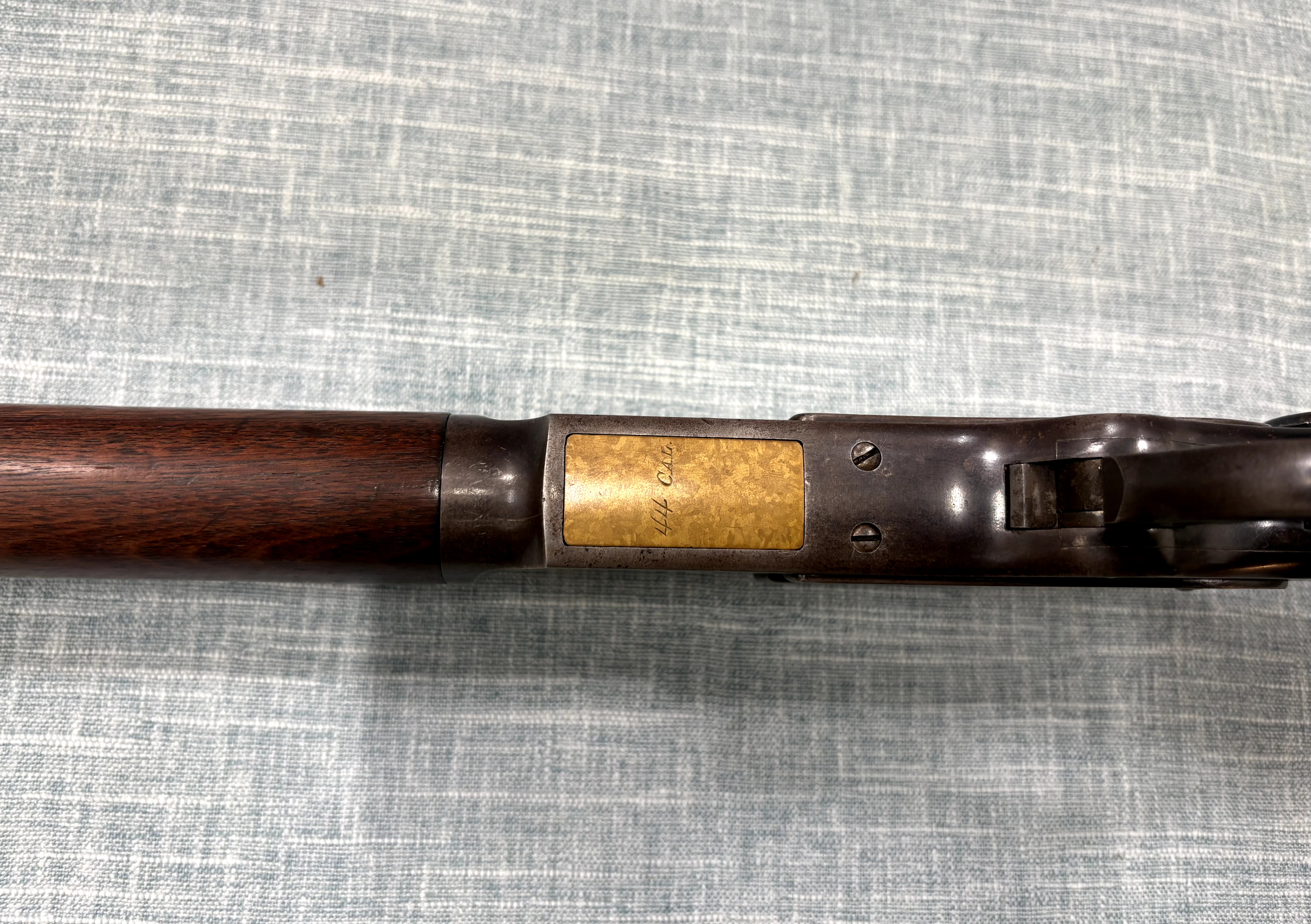 Winchester Model 1873 receiver underside and brass cartridge carrier marked 44 CAL